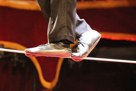 Close-up of feet on a tightrope