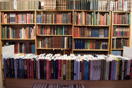 A photograph of several bookstore shelves loaded with books.