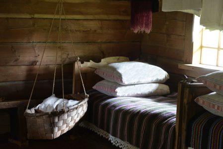 Image: log cabin bedroom with carrycot