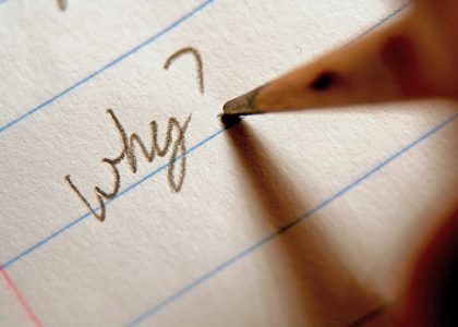 Image: pencil writing the question "Why?" on paper