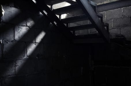 Image: dim light from top of basement stairs