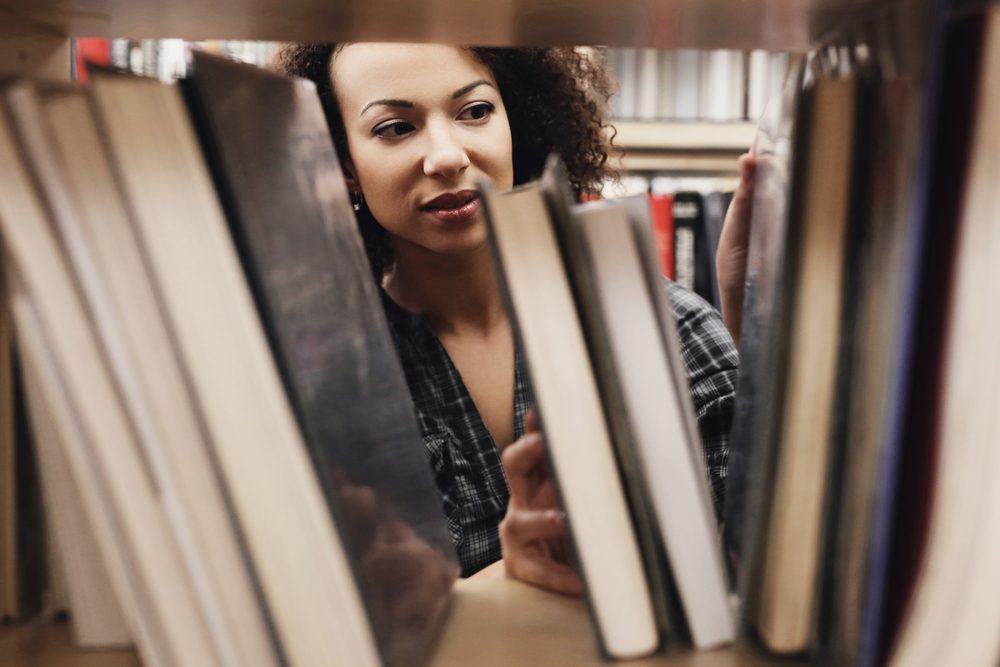 Image: woman browsing a bookshelf