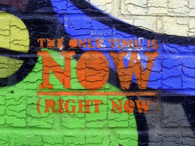 Image: wall mural with the words "the only time is now (right now)"