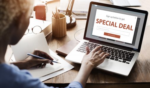 Image: woman at laptop with 'special deal' advertised on screen