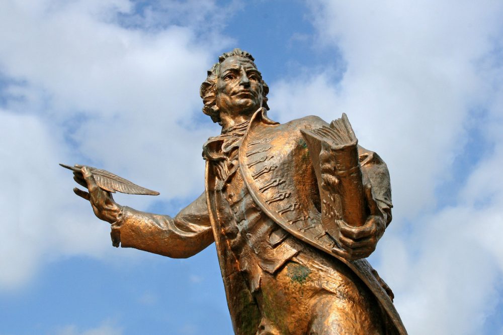 Image: statue of Thomas Paine holding book and quill pen