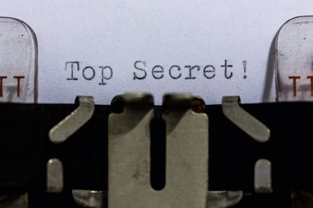 Image: typewriter typing the words "top secret"