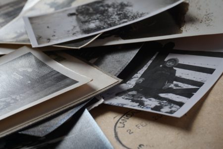 Image: a stack of old photos and letters.