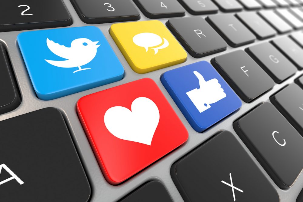 Resim: sosyal medya simgelerini taşıyan düğmeleri gösteren bir dizüstü bilgisayar klavyesinin yakın çekimi.