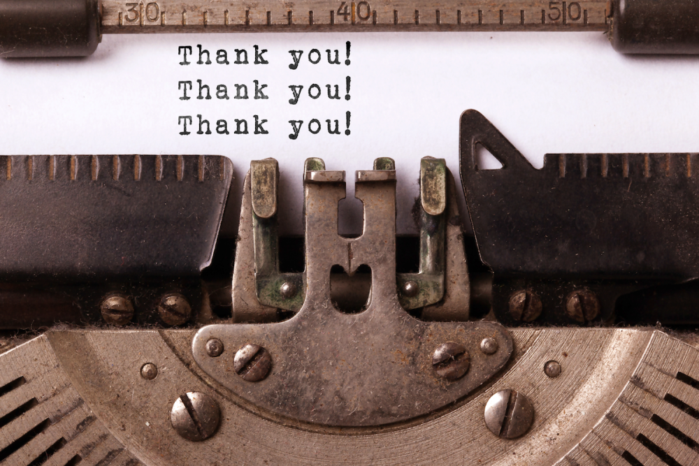 The phrase "Thank you!" typed three times on a typewriter.